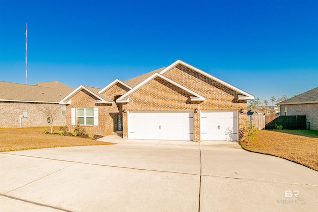 ranch-style house with fence, an attached garage, driveway, and brick siding