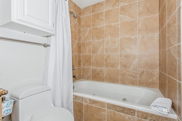 bathroom with tiled shower / bath combo and toilet