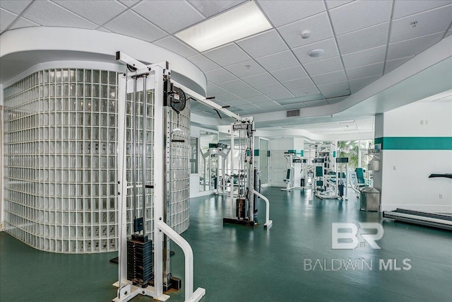 workout area featuring visible vents and a drop ceiling