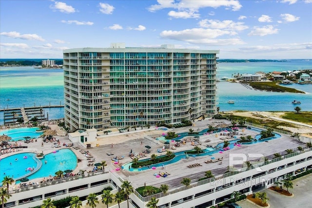 view of building exterior with a view of city and a water view