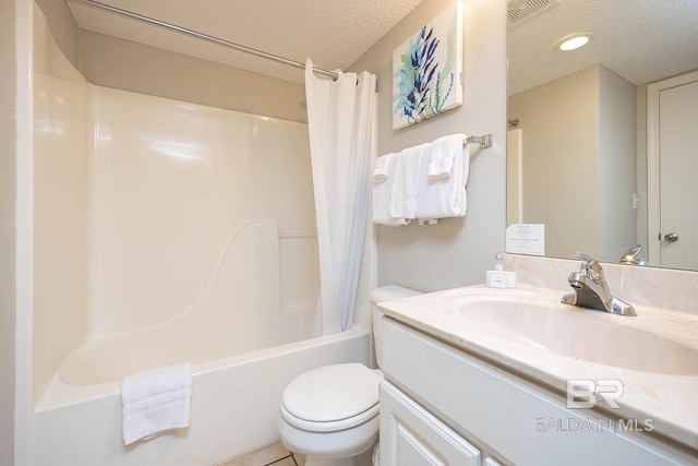 full bathroom featuring shower / bath combination with curtain, tile patterned flooring, a textured ceiling, vanity, and toilet