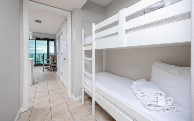 bedroom with light tile patterned floors