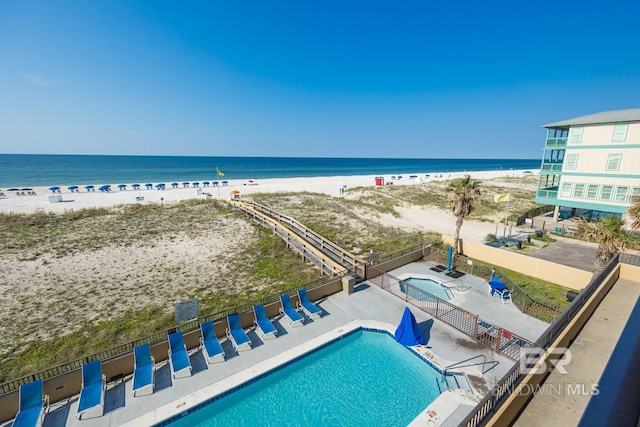 exterior space featuring a beach view and a water view