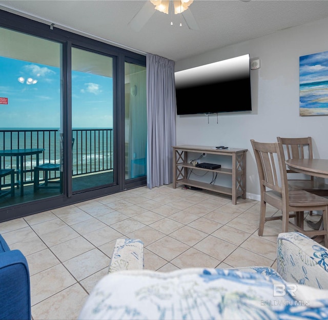 tiled living room featuring ceiling fan