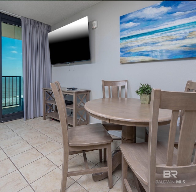 dining area featuring light tile patterned flooring