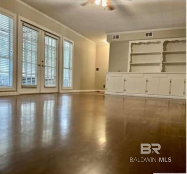 spare room with ornamental molding, a wealth of natural light, and ceiling fan