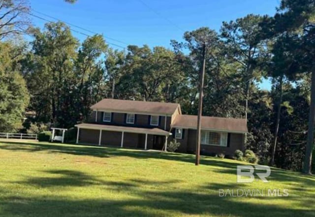 split level home featuring a front lawn