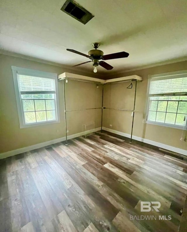 spare room with wood-type flooring and ceiling fan