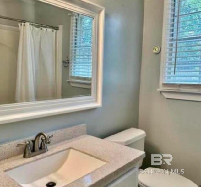 bathroom featuring vanity and toilet