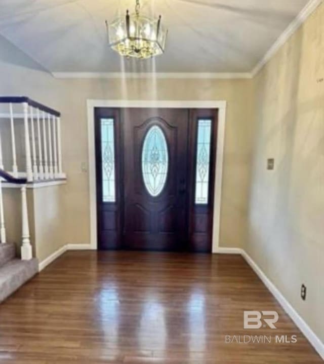 foyer entrance featuring hardwood / wood-style flooring and a chandelier