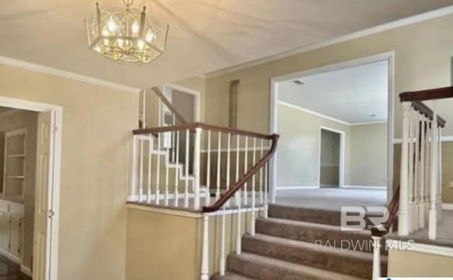 stairway with crown molding and a chandelier