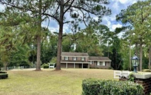 back of house with a lawn