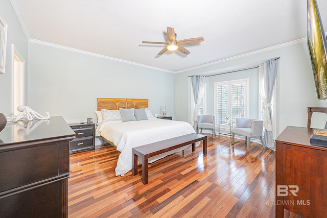 bedroom with ceiling fan, light hardwood / wood-style floors, and crown molding