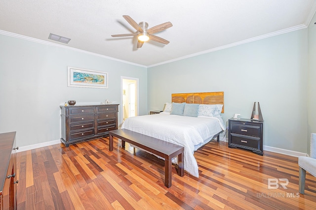 bedroom featuring ceiling fan, ornamental molding, and wood-type flooring