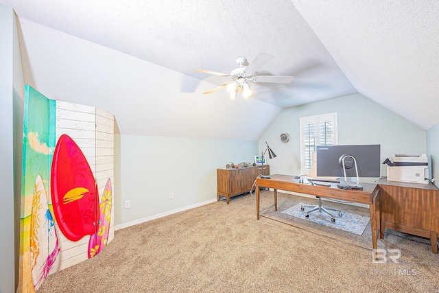 office space featuring carpet flooring, a textured ceiling, ceiling fan, and vaulted ceiling