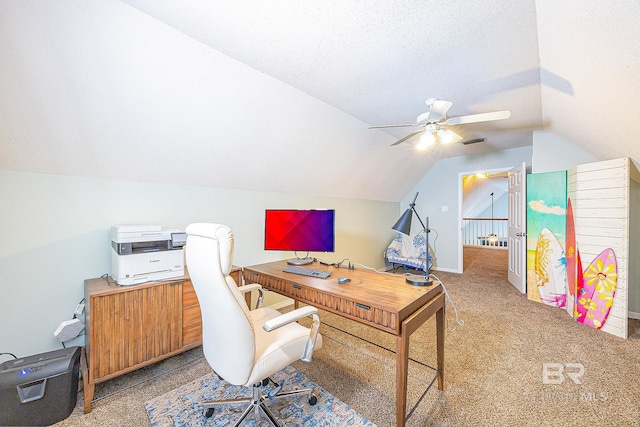 office area with ceiling fan, vaulted ceiling, a textured ceiling, and carpet flooring