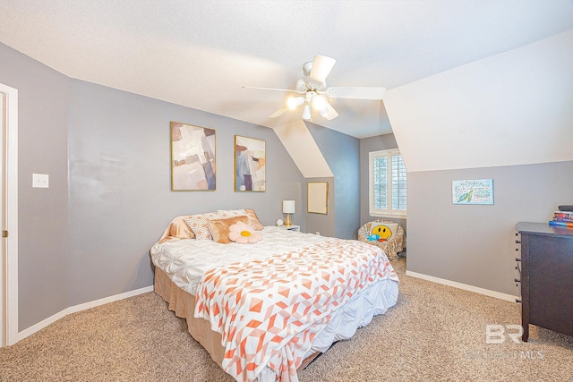 bedroom featuring lofted ceiling, a textured ceiling, ceiling fan, and light carpet