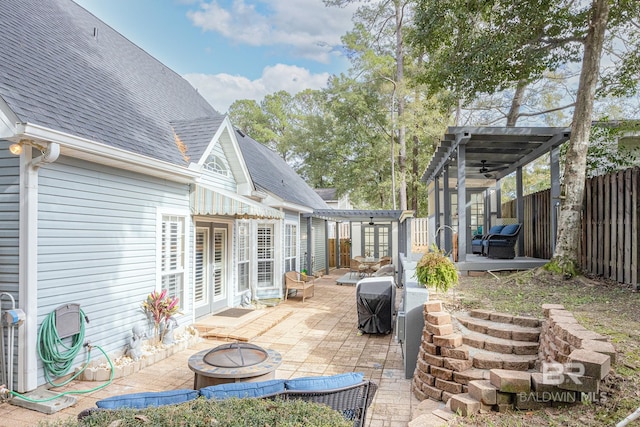 view of patio / terrace featuring a pergola, a fire pit, and french doors