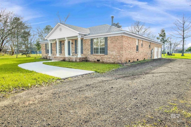 greek revival house with an attached garage, brick siding, a shingled roof, crawl space, and a front lawn