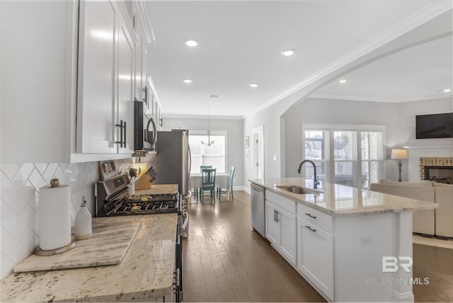 kitchen featuring white cabinetry, an island with sink, stainless steel appliances, and sink