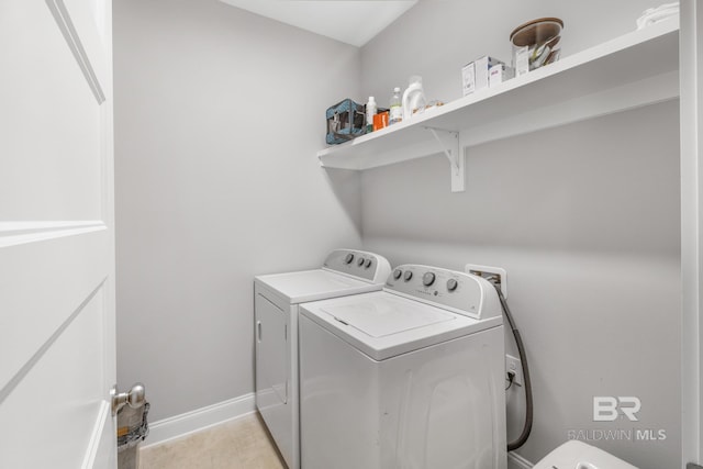 washroom with washing machine and clothes dryer