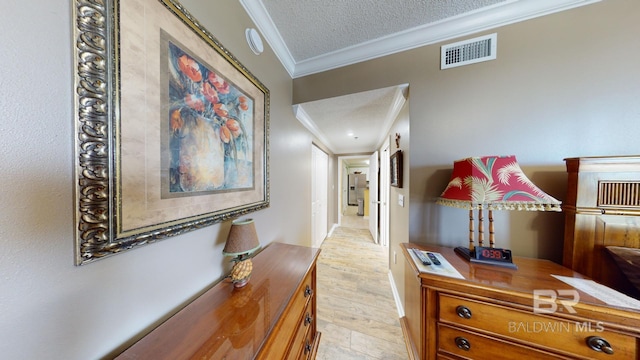 corridor featuring crown molding and a textured ceiling