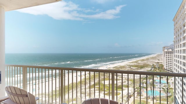 balcony featuring a water view and a view of the beach