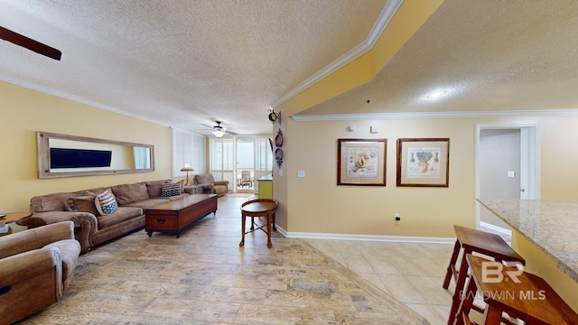 living room with ceiling fan, light hardwood / wood-style flooring, ornamental molding, and a textured ceiling