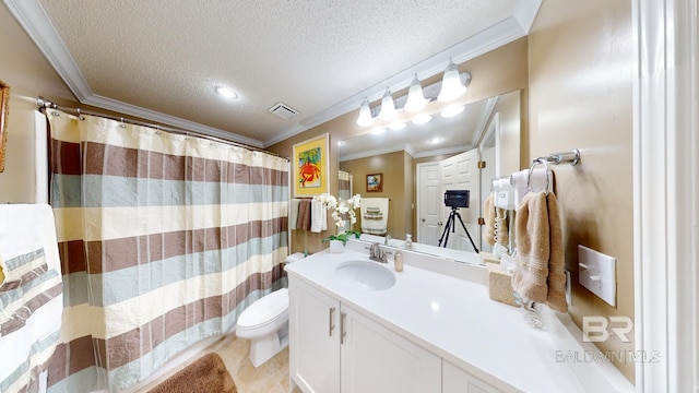 bathroom featuring crown molding, vanity, a textured ceiling, and toilet