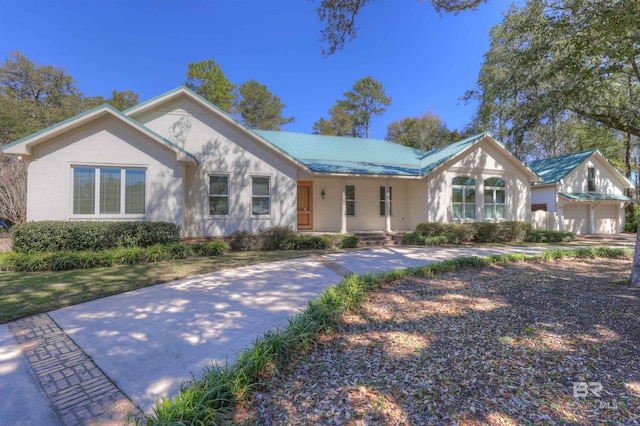 view of front of property featuring covered porch and metal roof