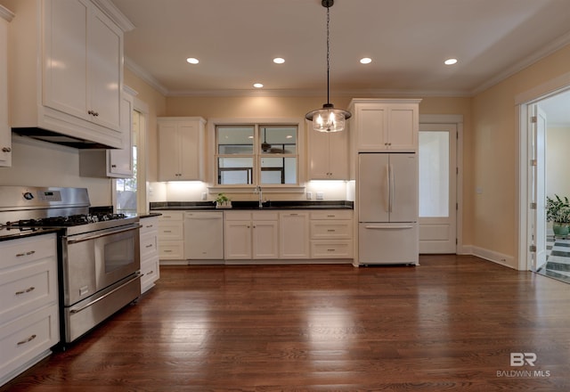 kitchen featuring ornamental molding, white appliances, dark wood-type flooring, and dark countertops