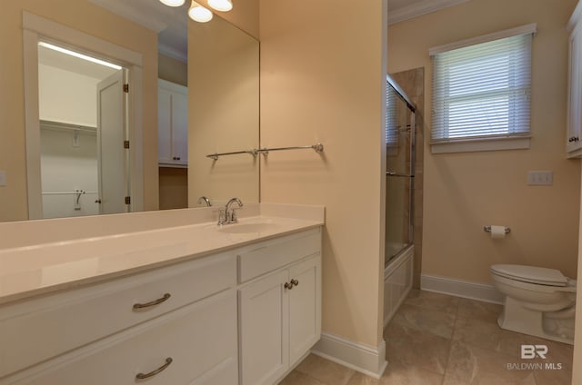 full bathroom with toilet, baseboards, crown molding, and vanity