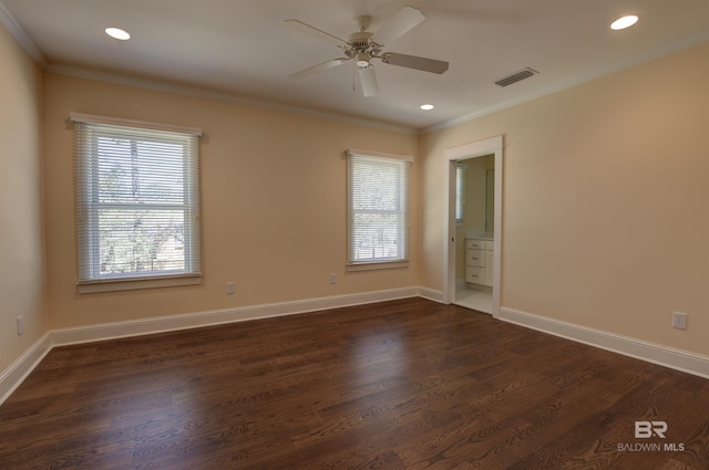 unfurnished room with dark wood-style floors, plenty of natural light, visible vents, and crown molding