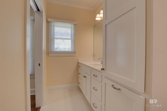 bathroom featuring baseboards, ornamental molding, and vanity