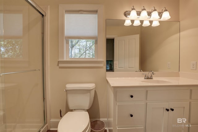 bathroom with a stall shower, vanity, and toilet