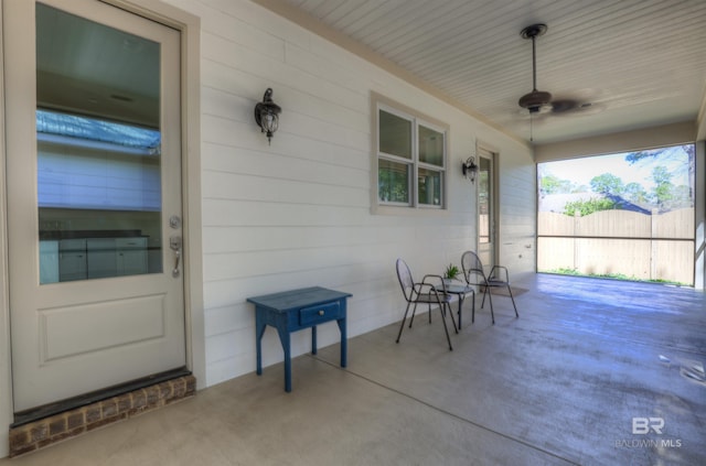 view of patio / terrace featuring ceiling fan and fence