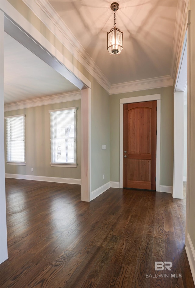 entryway featuring baseboards, dark wood finished floors, and crown molding