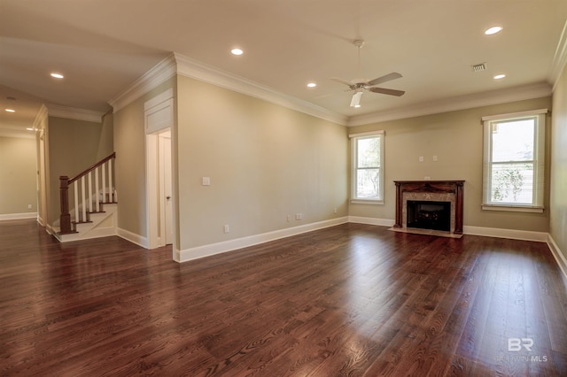 unfurnished living room with dark wood-style flooring, stairway, ornamental molding, a high end fireplace, and baseboards