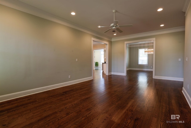 unfurnished room with ceiling fan, dark wood finished floors, and crown molding