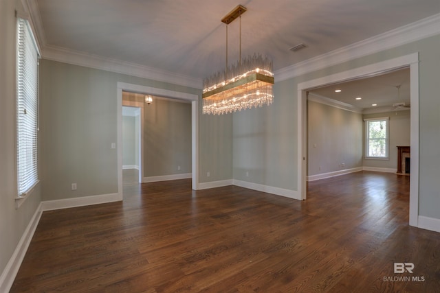 unfurnished room with dark wood-style floors, a fireplace, and crown molding