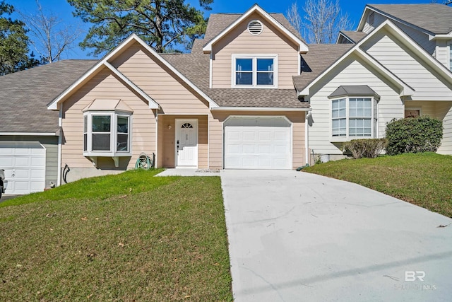 view of front facade featuring a front yard and a garage