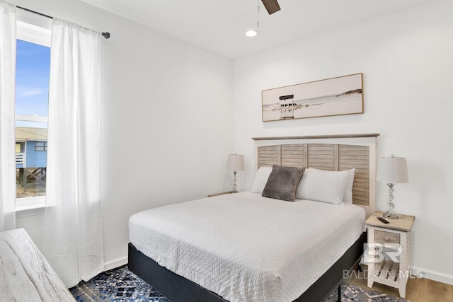 bedroom with hardwood / wood-style floors and ceiling fan