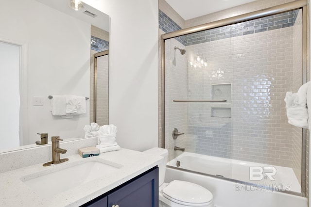 full bathroom with vanity, shower / bath combination with glass door, and toilet