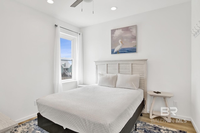 bedroom with hardwood / wood-style flooring and ceiling fan