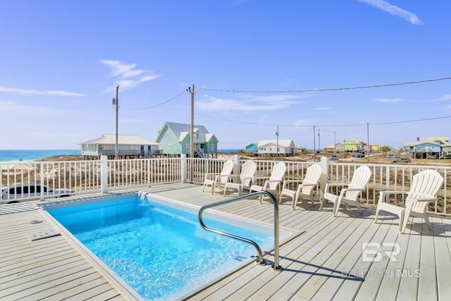 view of swimming pool featuring a deck with water view