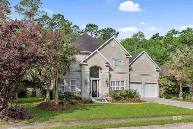 view of front of house with a front lawn and a garage