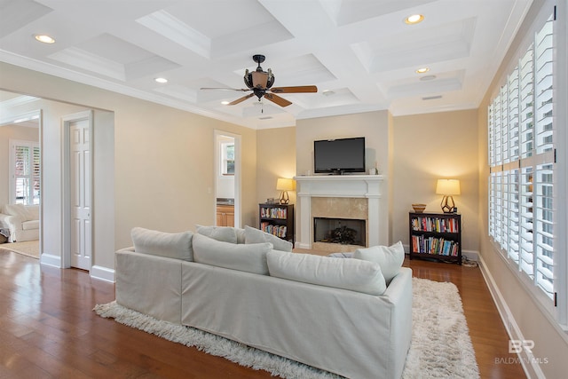 living room with ceiling fan, crown molding, dark hardwood / wood-style flooring, coffered ceiling, and beam ceiling