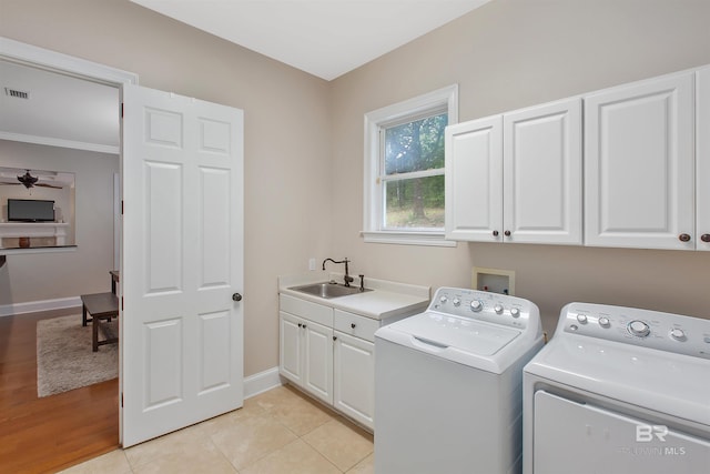 washroom with ceiling fan, light tile flooring, cabinets, sink, and washer and dryer