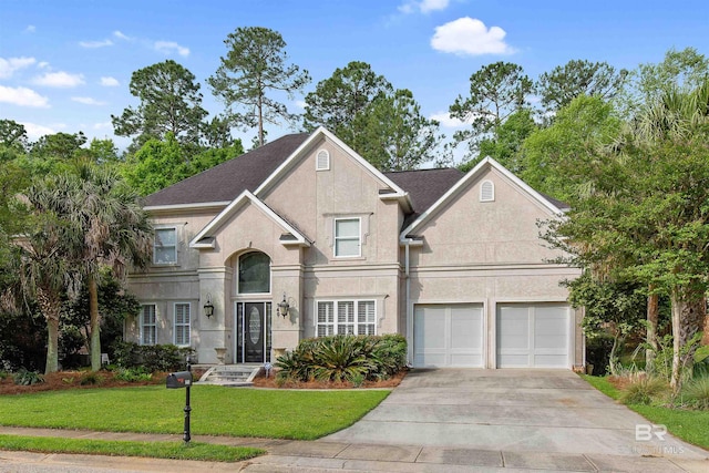 view of front of home with a front lawn and a garage