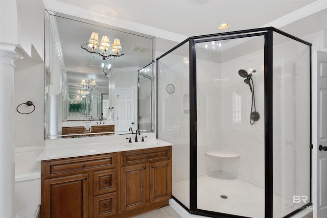 bathroom featuring an inviting chandelier, a shower with door, and oversized vanity